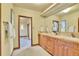 Bright bathroom featuring a double sink vanity with wood cabinets and a decorative mirror at 6057 Red Hill Rd, Boulder, CO 80302