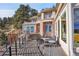 Home exterior from deck showing views of mountains and mature landscaping at 6057 Red Hill Rd, Boulder, CO 80302