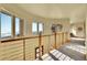 Sunlit upper hallway with stunning views and a modern wooden railing at 6057 Red Hill Rd, Boulder, CO 80302