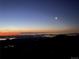 Stunning night view showcasing city lights under a vibrant twilight sky with a bright moon at 6057 Red Hill Rd, Boulder, CO 80302
