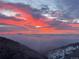 Mountain view featuring a sunset in a cloudy sky at 6057 Red Hill Rd, Boulder, CO 80302