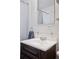 Bathroom featuring a white vanity, framed mirror, and chrome fixtures at 1580 Quince St, Denver, CO 80220