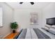 Bright bedroom featuring hardwood floors, a large window, and a stylish black and white bedspread at 1580 Quince St, Denver, CO 80220
