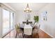 Dining room features a modern chandelier, a dining table for four, and tile floors at 1580 Quince St, Denver, CO 80220