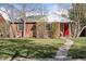 Charming brick ranch home with a well-manicured lawn and a vibrant red front door at 1580 Quince St, Denver, CO 80220