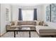 Cozy living room showcases neutral sectional sofa, plush rug, and stylish decor at 1580 Quince St, Denver, CO 80220
