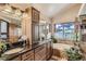 This bathroom offers a dual sink vanity, a soaking tub and natural light at 25875 Buffalo Ln, Golden, CO 80401