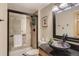 Bathroom with a black framed glass door shower, a vessel sink, and neutral walls at 25875 Buffalo Ln, Golden, CO 80401