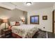 Comfortable bedroom features floral bedding, a wooden window frame, and lamps on the bedside table at 25875 Buffalo Ln, Golden, CO 80401