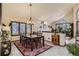 Bright dining room featuring large windows, a stylish chandelier, and seamless access to the living area at 25875 Buffalo Ln, Golden, CO 80401