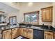 Kitchen with stainless steel appliances, granite countertops, wood cabinets, and a view to the backyard at 25875 Buffalo Ln, Golden, CO 80401