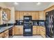 Kitchen with stainless steel appliances, granite countertops, and natural wood cabinetry at 25875 Buffalo Ln, Golden, CO 80401