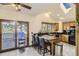 Open kitchen with granite countertops, black appliances, wood cabinets, bar seating, skylight and access to a deck at 25875 Buffalo Ln, Golden, CO 80401