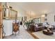 Open-concept living room featuring wood flooring, a staircase, and access to the dining area at 25875 Buffalo Ln, Golden, CO 80401