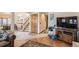 Spacious living room showcasing hardwood floors, an entertainment center, and a staircase at 25875 Buffalo Ln, Golden, CO 80401