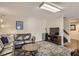 Cozy living room with modern lighting, a leather sofa, and patterned area rug at 25875 Buffalo Ln, Golden, CO 80401