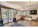 Living room with hardwood floors, dart board, and a sliding glass door to the hot tub at 25875 Buffalo Ln, Golden, CO 80401