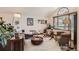 Spacious living room featuring large windows, a cozy seating area, and stylish decor at 25875 Buffalo Ln, Golden, CO 80401