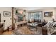 Cozy living room with a brick fireplace, and a comfortable sofa bathed in natural light at 25875 Buffalo Ln, Golden, CO 80401