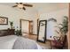 This main bedroom offers a ceiling fan, wood floors, a mirror and natural light at 25875 Buffalo Ln, Golden, CO 80401