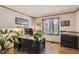 A well-lit home office with a large wooden desk, built-in storage, and plenty of natural light from the window at 25875 Buffalo Ln, Golden, CO 80401