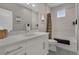 Bathroom featuring a vanity with a large mirror and cabinets, a toilet, and a shower-bath combo at 8982 Delacorte St, Littleton, CO 80129
