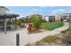 Walking path view to a common green space with a covered picnic area and neighborhood homes in background at 8982 Delacorte St, Littleton, CO 80129