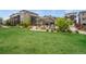 Community space with a covered seating area, fire pit, and green grass lawns for relaxing outside at 8982 Delacorte St, Littleton, CO 80129