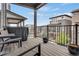 Outdoor deck area with seating, a grill, and views of the surrounding neighborhood at 8982 Delacorte St, Littleton, CO 80129