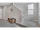 Bright entryway featuring neutral walls, carpeted stairs, bench, and a modern coat rack at 8982 Delacorte St, Littleton, CO 80129