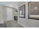 Neutral entryway with white door and modern artwork, creating a welcoming ambiance at 8982 Delacorte St, Littleton, CO 80129