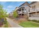 Charming townhomes with private balconies, professional landscaping, and inviting curb appeal at 8982 Delacorte St, Littleton, CO 80129