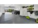 Painted garage with epoxy flooring, a black SUV, and wall-mounted tool storage at 8982 Delacorte St, Littleton, CO 80129