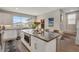 Bright kitchen with a large island, modern appliances, and ample counter space at 8982 Delacorte St, Littleton, CO 80129
