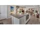 Contemporary kitchen island featuring a built-in microwave and seating for casual dining at 8982 Delacorte St, Littleton, CO 80129
