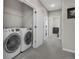 Convenient laundry room area with a modern washer and dryer, plus additional storage space at 8982 Delacorte St, Littleton, CO 80129
