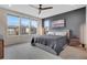 Serene bedroom featuring large windows, a plush bed, and stylish decor at 8982 Delacorte St, Littleton, CO 80129
