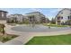 Neighborhood playground featuring climbing structures and green space between modern townhomes at 8982 Delacorte St, Littleton, CO 80129