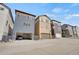 Street view of modern townhomes with attached garages and varying exterior color schemes at 8982 Delacorte St, Littleton, CO 80129