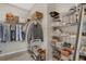 Walk-in closet with rods and shelving for clothing, shoes, and accessories at 8982 Delacorte St, Littleton, CO 80129