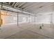 Expansive unfinished basement with exposed ceilings and support posts, offering versatile potential at 1613 Bloom St, Brighton, CO 80601