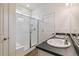 This bathroom boasts a glass enclosed shower, double sink vanity with modern fixtures, and a window for natural light at 1613 Bloom St, Brighton, CO 80601