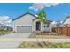 Charming single-story home with a two-car garage and a well-manicured front yard at 1613 Bloom St, Brighton, CO 80601