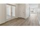 A long hallway with wood look floors shows great flow throughout the home at 1613 Bloom St, Brighton, CO 80601