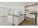 Open-concept kitchen with island, stainless steel appliances, and view to living area at 1613 Bloom St, Brighton, CO 80601