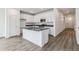 Bright kitchen features white cabinets, stainless steel appliances, and a dark countertop island at 1613 Bloom St, Brighton, CO 80601