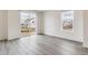 Bright living space featuring hardwood flooring, large windows and sliding glass door at 1613 Bloom St, Brighton, CO 80601