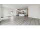 Open-concept living area with kitchen, stainless appliances and abundant natural light at 1613 Bloom St, Brighton, CO 80601