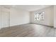 Bright living space featuring hardwood flooring and large window at 1613 Bloom St, Brighton, CO 80601