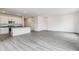 Open-concept living area with kitchen, stainless appliances and abundant natural light at 1613 Bloom St, Brighton, CO 80601